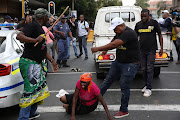 ANC supporters attack a bakkie suspected to be carrying BLF members, outsude Luthuli House in Johannesburg.