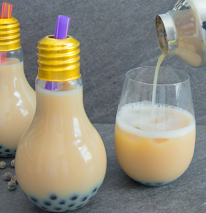 photo of tea being poured into a glass