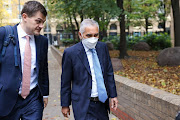 Kalidas Madhavpeddi, chair of Glencore, right, arrives at Southwark Crown Court in London on Wednesday. Glencore officials delivered cash in private jets to officials across Africa, UK prosecutors said. 