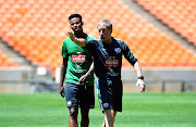 Bafana Bafana head coach Stuart Baxter in a discussion with France-based midfielder Bongani Zungu during a training session at FNB Stadium.