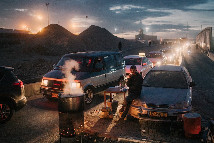 Cars wait to pass through a checkpoint at Ramallah in the West Bank to enter Israel, 2018.