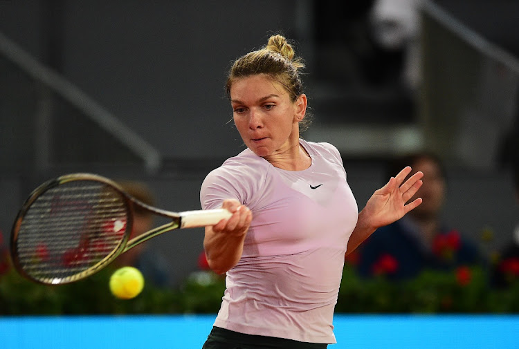 Simona Halep of Romania plays a forehand in her third round match against Coco Gauff of the United States in the Madrid Open at La Caja Magica on May 2, 2022