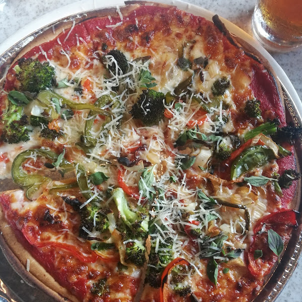 The GF pizza is cooked in. Foil tray. The cauliflower crust is not, so is not Celiac safe.