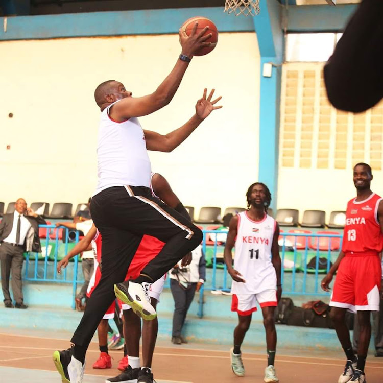 ICT CS Eliud Owalo, a former basketball player, displays his skills after donating uniforms to Kenya men's national basketball team, the Morans on February 14.