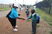 At Abram Hlophe Primary School in Katlehong teachers had their hands full directing pupils to their new classrooms. 