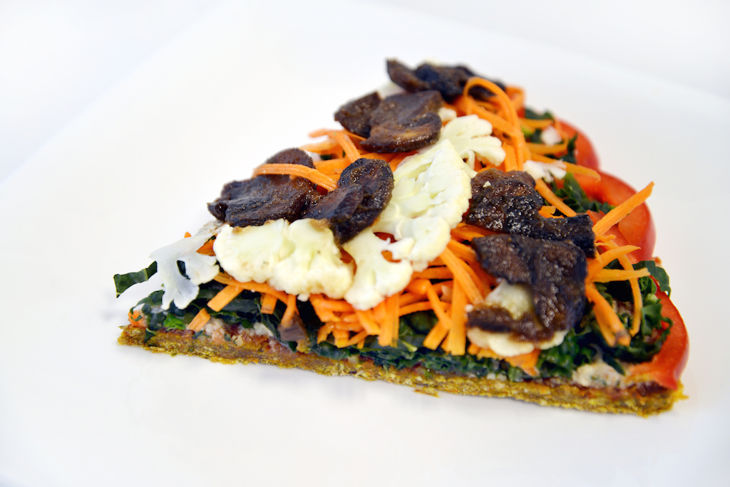 Rawkin' Pizza with a sprouted buckwheat and flax crust, Dill Nut Cheese, Sweet Chili Sauce, kale, carrots, cauliflower, bell pepper, marinated mushrooms