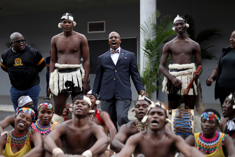 US ambassador Reuben E Brigety II shouts 'amandla' as he is welcomed by a traditional dance group during his visit at University of KwaZulu-Natal, Edgewood Campus, in Durban.