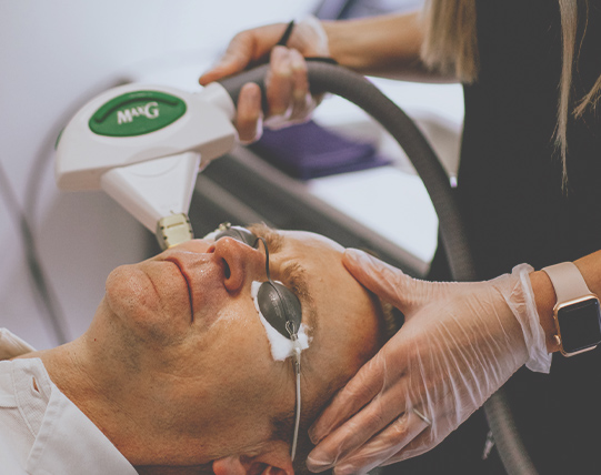 The doctor performing a dry eye treatment procedure with Icon IPL by CynoSure