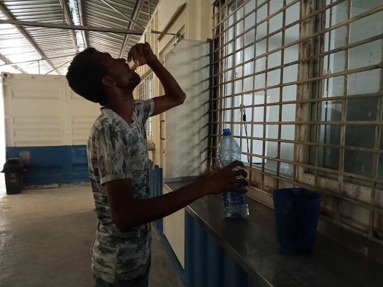 An addict takes his dose of methadone at the Lamu clinic.