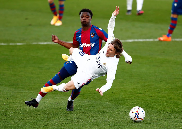 Real Madrid's Luka Modric in action with Levante's Mickael Malsa