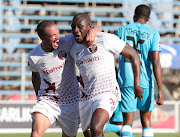 Ruzaigh Gamildien (L) celebrates with goalscorer Joseph Mhlongo (R) who scored the winning goal for Swallows FC away against Black Leopards in a DStv Premiership match at Thohoyandou Stadium in Venda on December 20 2020. 