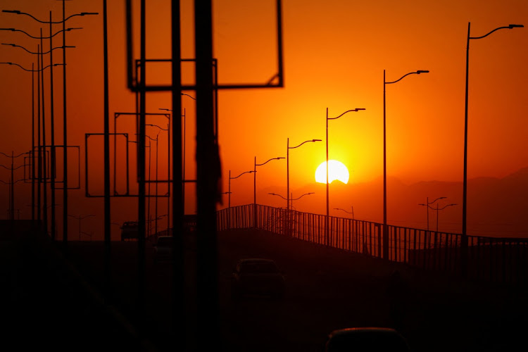 The sun sets on New Year's Eve in Peshawar, Pakistan, December 31 2022. Picture: FAYAZ AZIZ/REUTERS