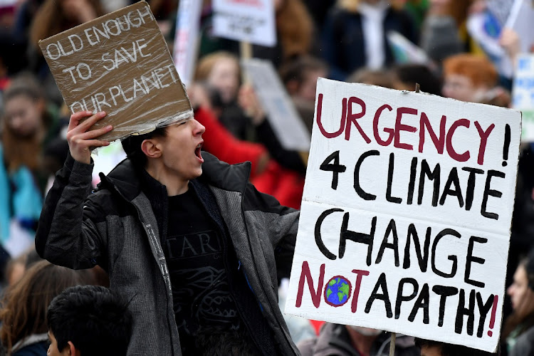 School children hold placards and shout slogans as they participate in a protest against a lack of climate awareness outside the Scottish parliament on March 15 2019 in Edinburgh, Scotland. Picture: GETTY IMAGES/JEFF MITCHELL