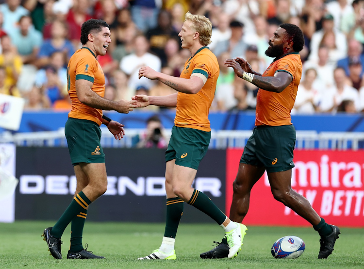 Ben Donaldson of Australia celebrates with Carter Gordon and Marika Koroibete after scoring his team's fourth try during the Rugby World Cup match against Georgia at Stade de France on September 09, 2023 in Paris, France.
