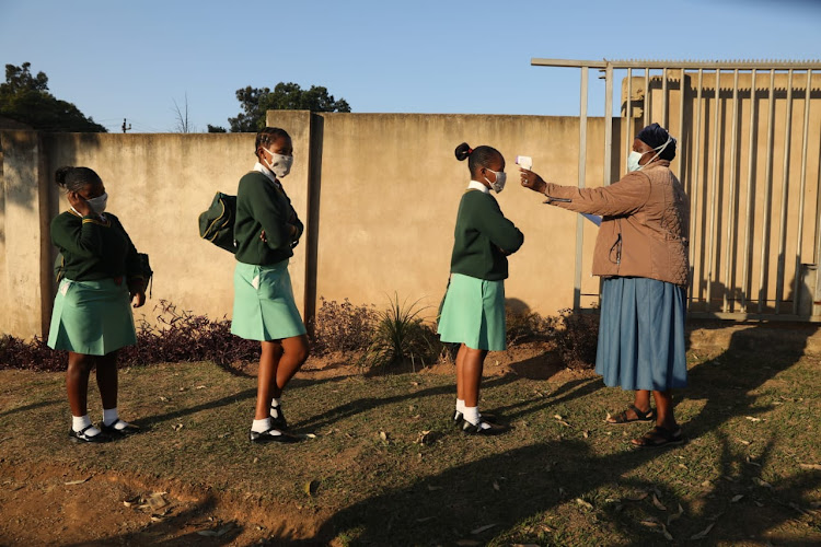 Andiso Mthiyane, Nqobile Ngidi and Samukelisiwe Hlengwa, matric pupils at Sibusisiwe Comprehensive School in Mbulumbulu being screened by Sibongile Gumede.