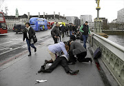 Westminster Bridge, near the Houses of Parliament in London, was littered with the injured, knocked down by a car that mounted the pavement. File photo.