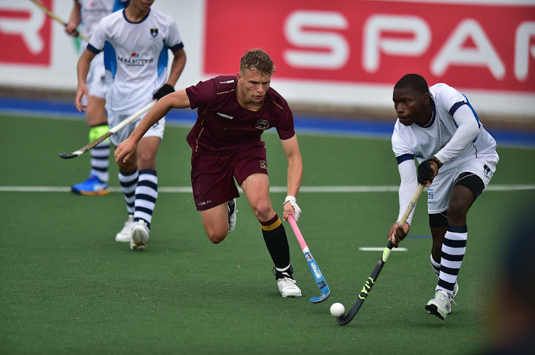 Paul Roos Gym's Reuben Sendzul, left, and Wayne Mandabva of SACS duel for possession during the Hibberth Shield hockey final at the Rectory astro at Grey High on Sunday