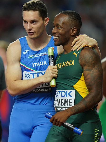 Filippo Tortu of Italy celebrate with Akani Simbine of South Africa at the finish line of the 4x100 m, preliminary heat, at the World Championships. .