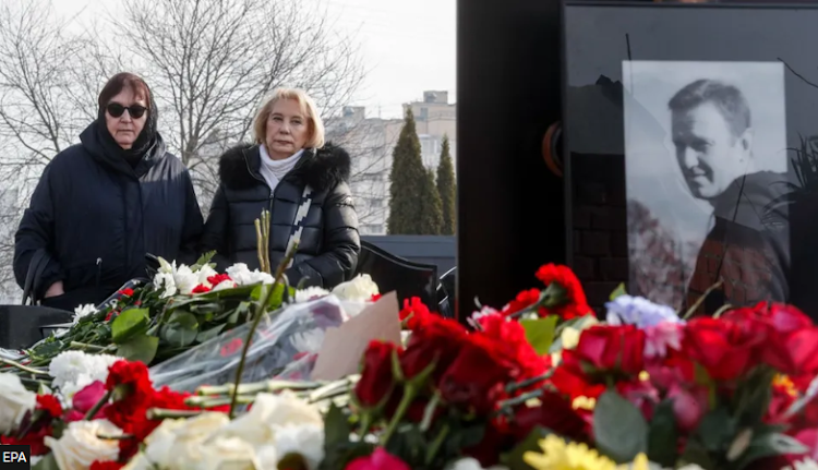 Lyudmila Navalnaya, mother of late Russian opposition leader Alexei Navalny, mourns near her son's grave at a cemetery on the outskirts of Moscow