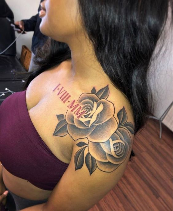 lady with a flower and text shoulder tattoo chilling