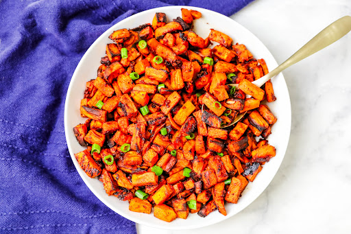 A large bowl of Spicy Roasted Sweet Potatoes.