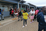 Family members and supporters of slain Umlazi cop Thomas Ntombela protest outside court as his wife, Faith Nongcebo Ntombela, and principal Sthembiso Khumalo, charged with his murder, begin their bail applications.