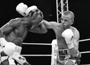 FENDING BLOWS: Siphiwe Nongqayi blocks a punch from Malik Bouziane during their IBF junior bantamweight title fight in France last Friday. 09/04/2010 © Unknown.