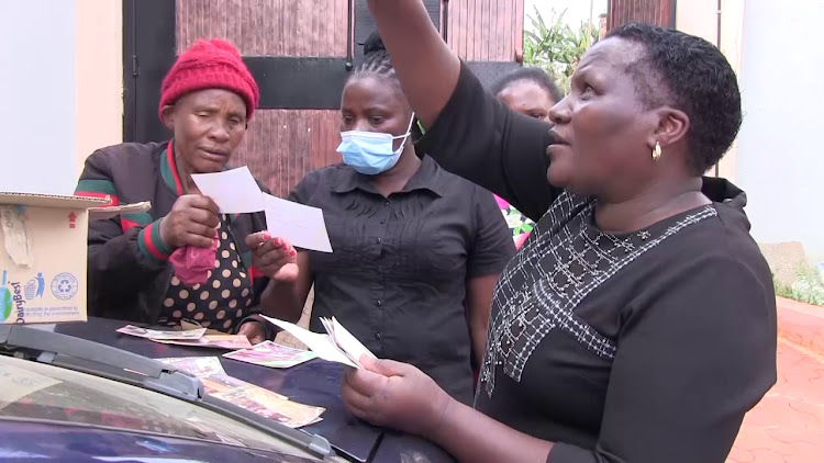 Eunice Ndung'u (right) with Kandara women at her home on Mashujaa Day.