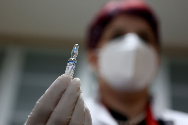 A healthcare worker prepares a dose of Russia's Sputnik V Covid-19 vaccine.