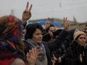 A woman gestures during a protest near the Syrian-Turkish border in Ras al-Ayn, Syria, on December 20 2018. 