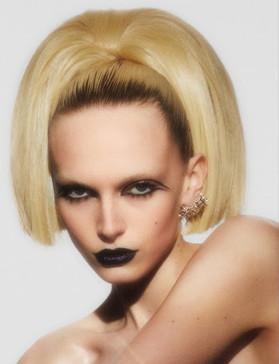 Model Alex Consani in a black eyeliner and black lipstick with a high blonde ponytail.