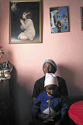 Kehapilwe Sehau holds her daughter Boitumelo almost a week after the death of her baby Lehlonolo in Bloemhof