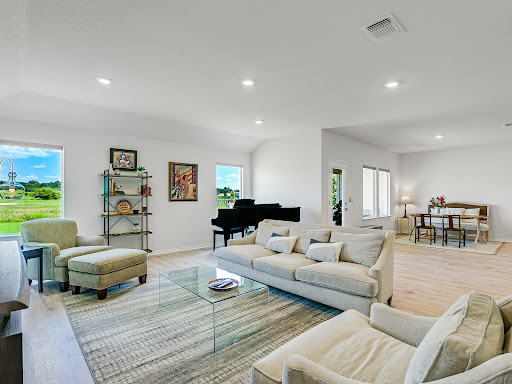 Living room with piano and country view in this luxury property for sale in Bastrop ($399,000)