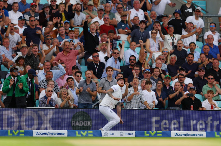 England captain Ben Stokes takes a catch to dismiss Australia's Pat Cummins off the bowling of Joe Root at The Oval.