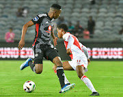 Asanele Velebayi of Cape Town Spurs is challenged by Mbatha Thalente of Orlando Pirates in their DStv Premiership match at Orlando Stadium on Wednesdy night. 