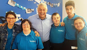 Comedian Barry Hilton with staff at Brownies & Downies.