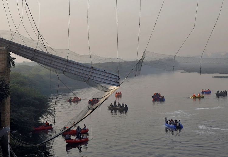 Rescuers search for survivors after a suspension bridge collapsed in Morbi town in the western state of Gujarat, India, October 31, 2022.