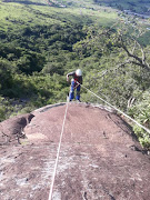 SAPS removing the graffiti painted by Mancoba Seven Angels Ministeries Church on a mountain behind Khalinyanga village.