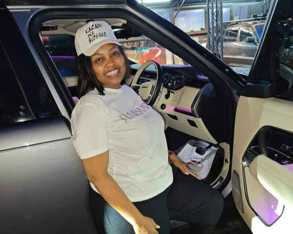 Ex-nominated senator Millicent Omanga poses for a photo with the new Ranger Rover.