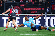 Bulls' Sergeal Petersen misses a tackle on Thaakir Abrahams of Lyon during their Champions Cup match at Matmut Stadium de Gerland, Lyon, France, on December 16 2023.