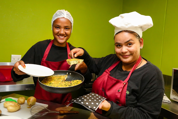 Petronella Karelse,19, and Renecia Adams, 23, show off their new cooking skills