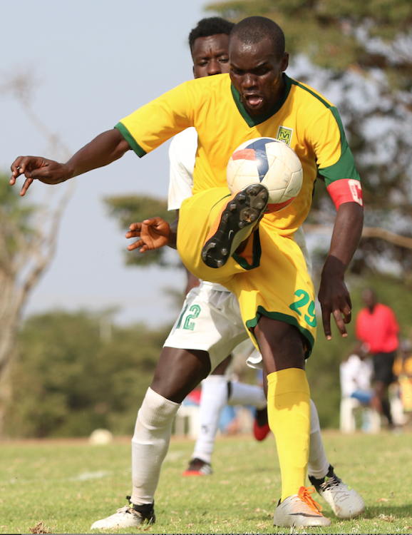 Mathare's Norman Ogolla shields the ball from Douglas Mokaya of Kariobangi Sharks during a pastPremier League clash at Kasarani.