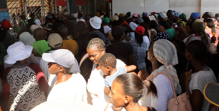 A big crowd gathers at the Motherwell Shopping Centre to claim their Sassa grant money to buy essential supplies