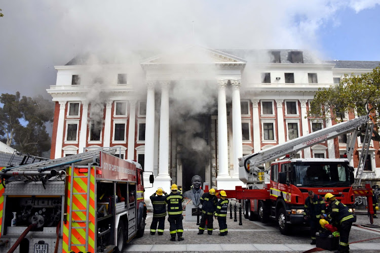 Firefighters work to put out a fire at the parliamentary precinct in Cape Town on January 2 2022.