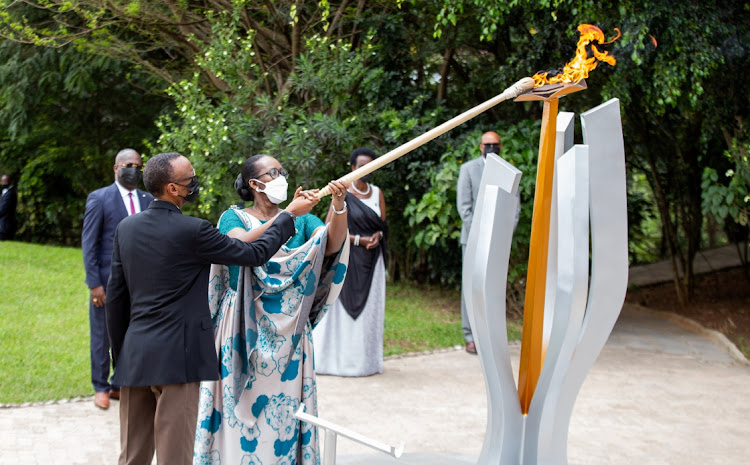 President Paul Kagame and first lady Jeanette Kagame light the Rwandan genocide flame of hope, known as the "Kwibuka" (Remembering), to commemorate the 1994 Genocide, at the Kigali Genocide Memorial Center in Kigali, Rwanda on April 7, 2021.