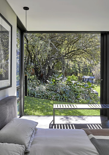 The master bedroom was extended adding another glass box with a sliding glass door that opens to the garden.