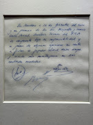 A signed and framed napkin on which soccer club Barcelona promised to sign a 13-year-old Lionel Messi is displayed at the Bonhams auction house in London, Britain May 8, 2024. 