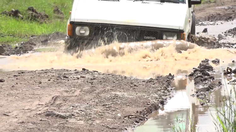 A section of the road that is in a deplorable state, especially during the ongoing heavy rains.