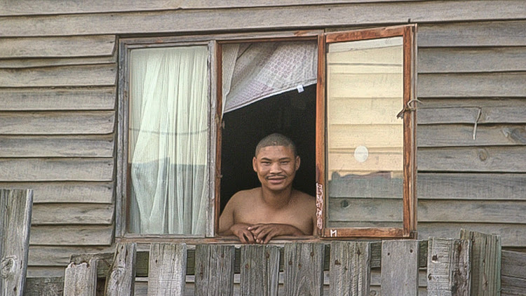 A Delft resident watches the neighbourhood safety team from his home window.