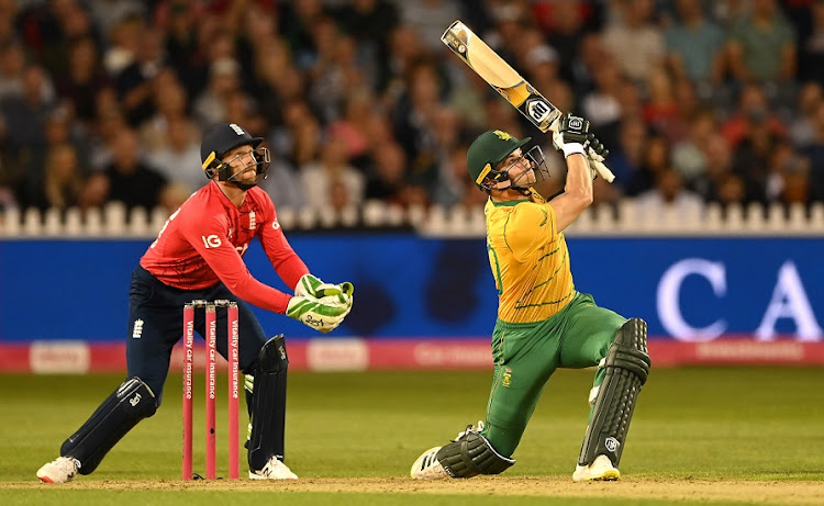 SA batsman Tristan Stubbs hits a six, watched by England's Jos Buttler, in the first T20 International at Bristol County Ground on July 27 2022.